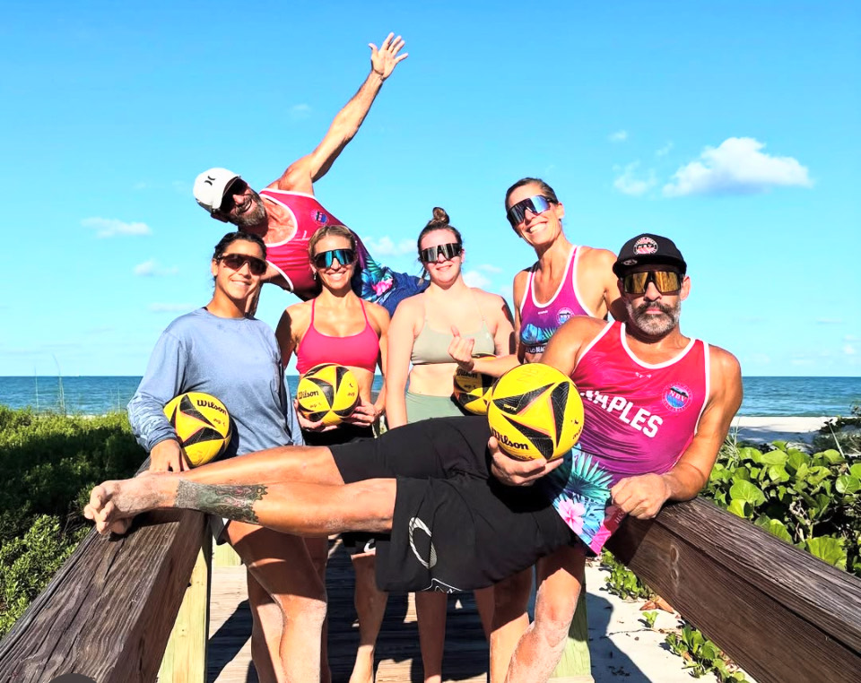 Beach Fit participants exercising together on the sand in Naples, Florida