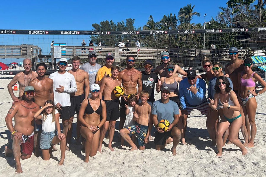 Beach volleyball players celebrating a point in Naples